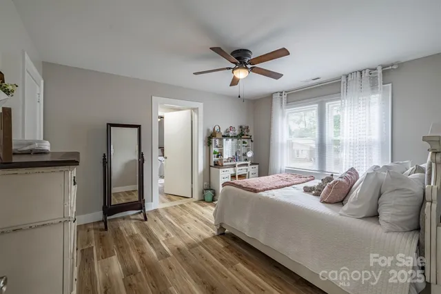 a bed room with a bed and a ceiling fan
