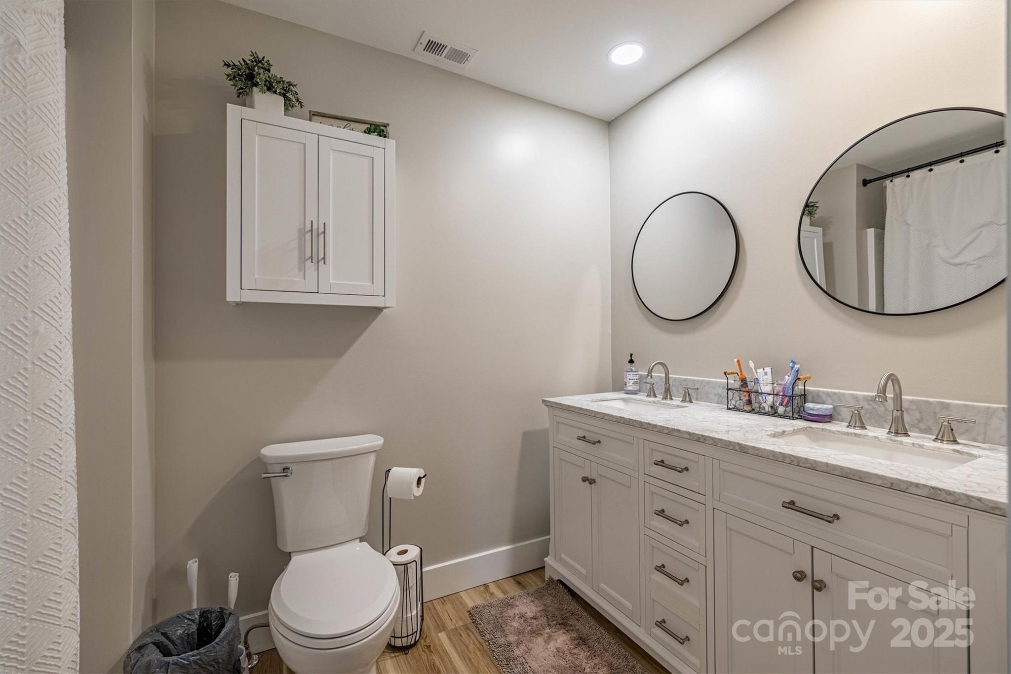 2625 20th St Lane Northeast Hickory, NC 28601 - Photo 27 of 31 a bathroom with a toilet a sink a mirror and a window
