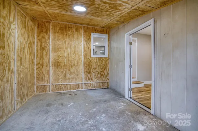 a view of an empty room with wooden door