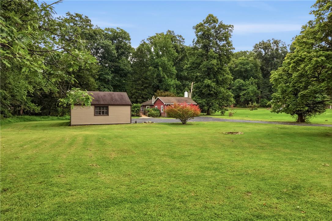 3573 Lower Saucon Road Hellertown, PA 18055 - Photo 25 of 56 Mature trees frame a sprawling lawn surrounding a detached outbuilding and a main residence.