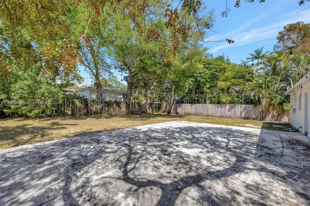 a view of swimming pool with sitting area and garden