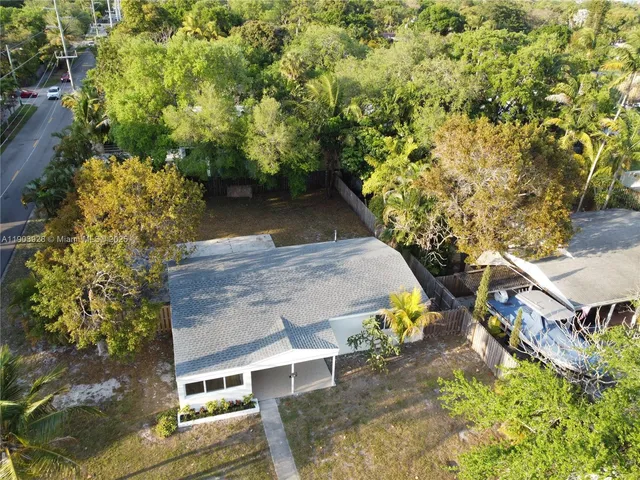 an aerial view of a house with a yard basket ball court and outdoor seating