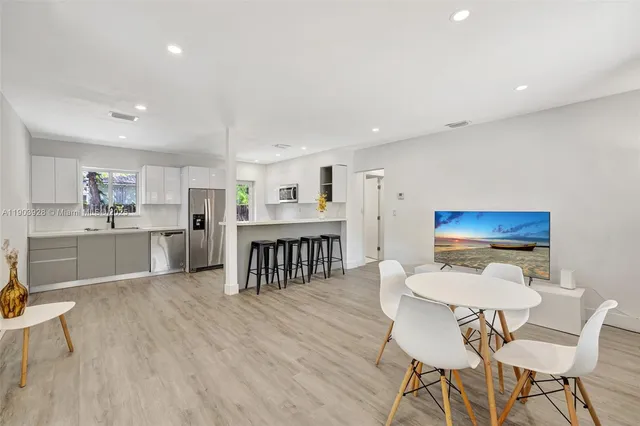 a kitchen with a table and chairs in it