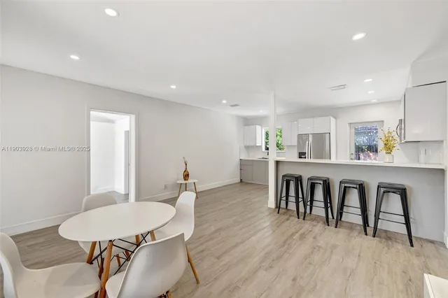 a dining room with furniture and wooden floor