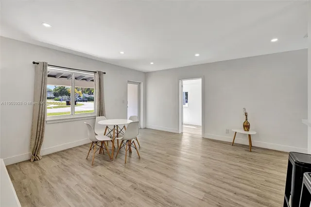 a dining room with furniture and wooden floor