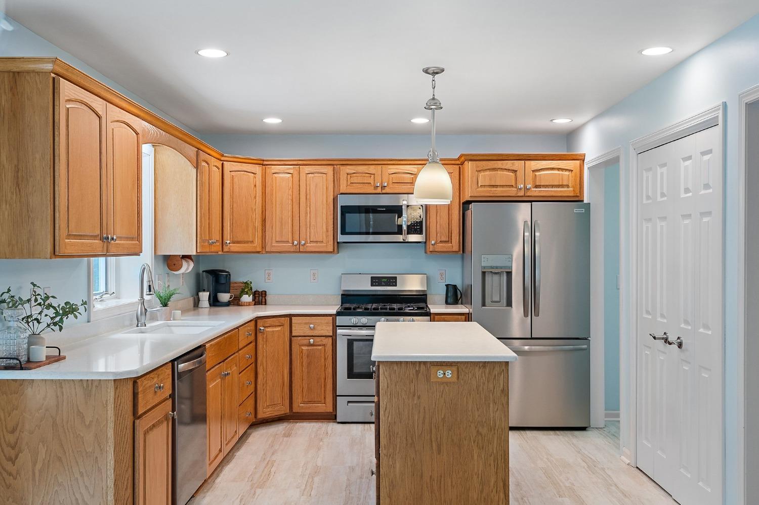 5964 West Schultz Road La Porte, IN 46350 - Photo 19 of 53 a kitchen with stainless steel appliances granite countertop a refrigerator a sink dishwasher a oven with large countertops and wooden floor