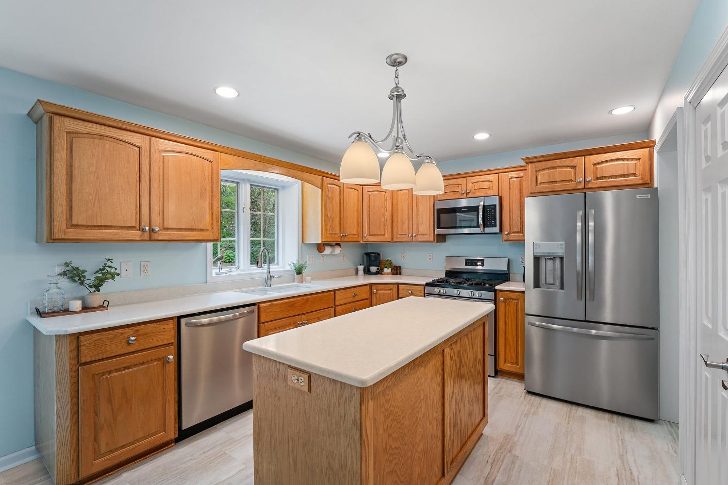5964 West Schultz Road La Porte, IN 46350 - Photo 20 of 53 a kitchen with a refrigerator a sink dishwasher and wooden cabinets with wooden floor