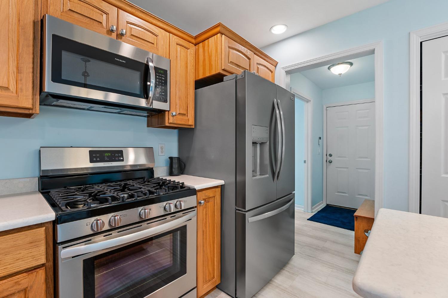 5964 West Schultz Road La Porte, IN 46350 - Photo 23 of 53 a kitchen with stainless steel appliances granite countertop a stove microwave and refrigerator