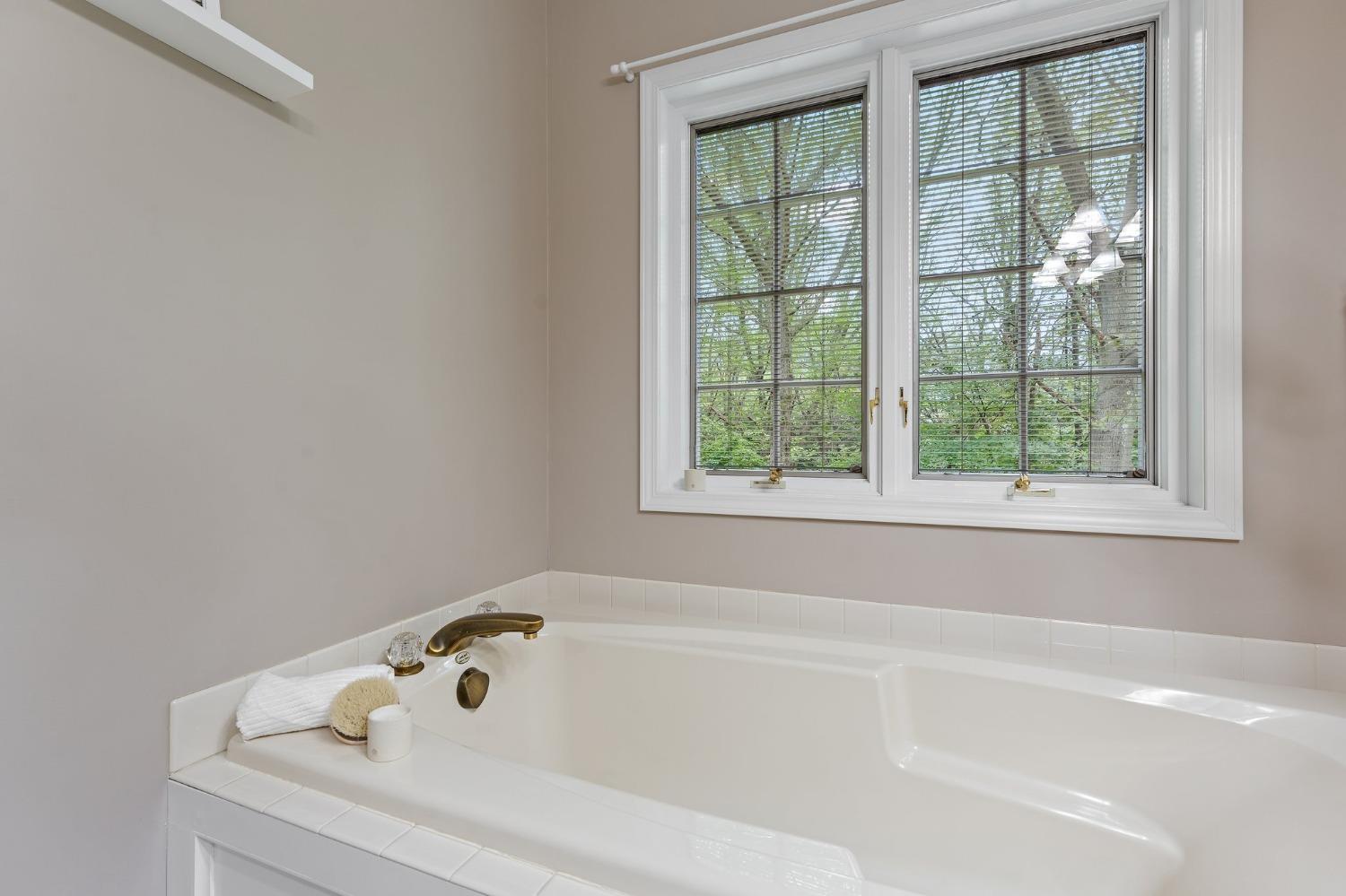 5964 West Schultz Road La Porte, IN 46350 - Photo 36 of 53 a white bath tub sitting next to a window