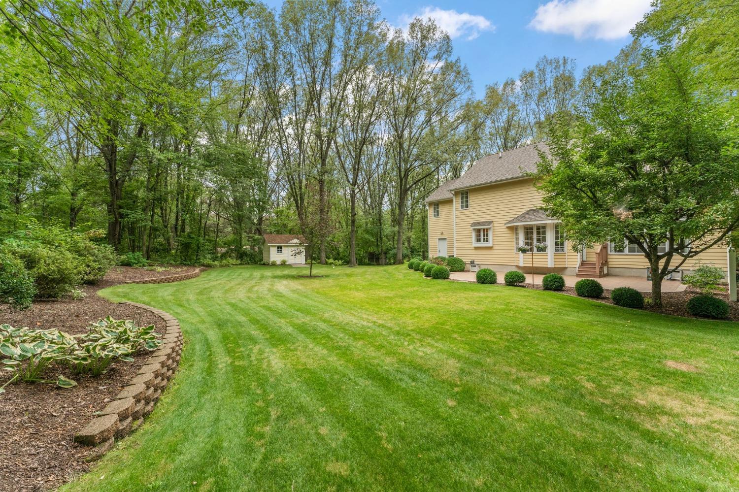 5964 West Schultz Road La Porte, IN 46350 - Photo 46 of 53 a view of a white house in front of a big yard with large trees