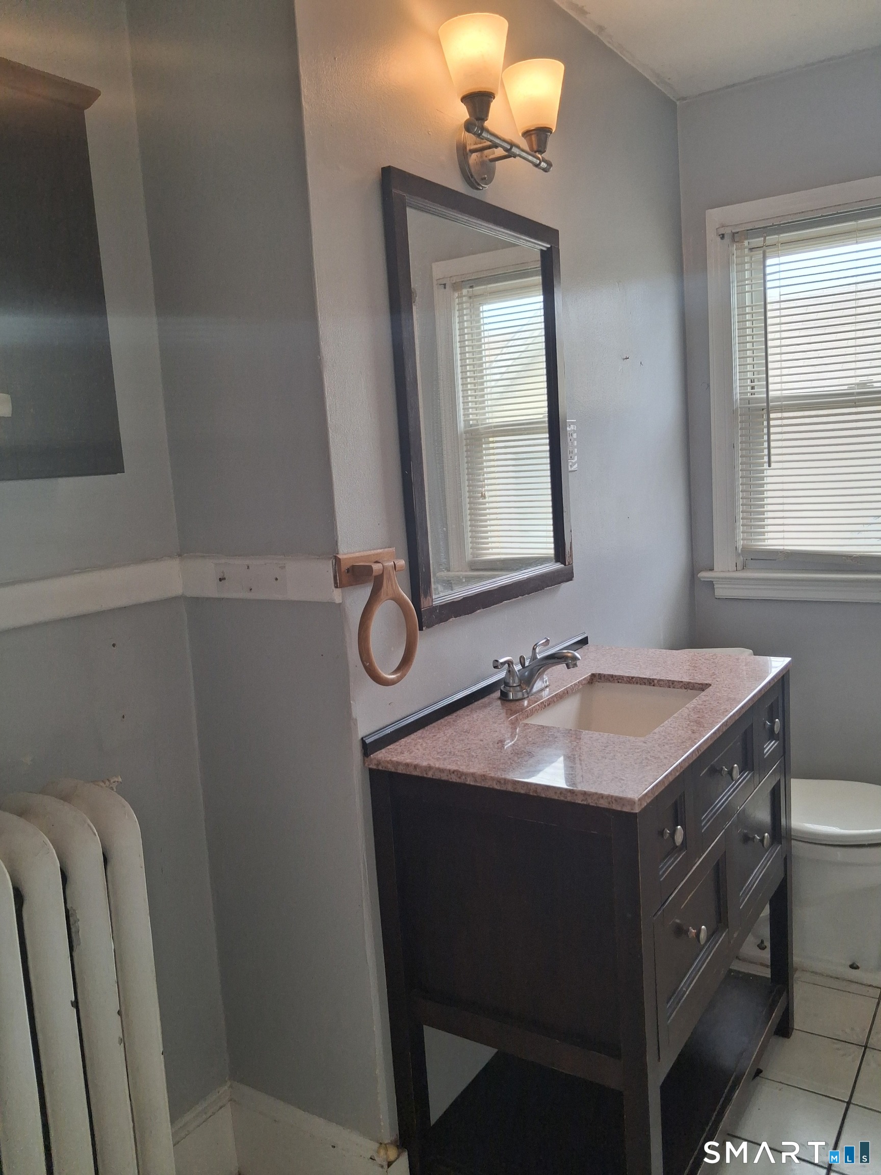 26 4th Street Hamden, CT 06514 - Photo 27 of 40 a bathroom with a sink and a mirror
