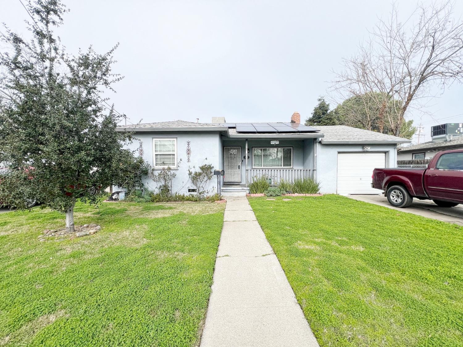 a front view of house with yard and trees