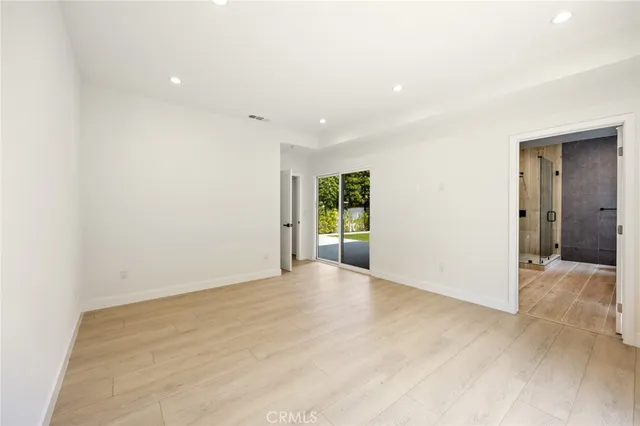 a kitchen with stainless steel appliances kitchen island granite countertop a refrigerator and a stove top oven
