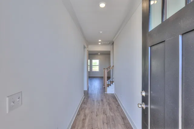 a view of a hallway with wooden floor