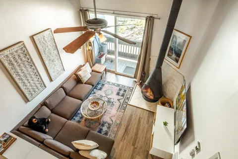 a living room with furniture and a floor to ceiling window