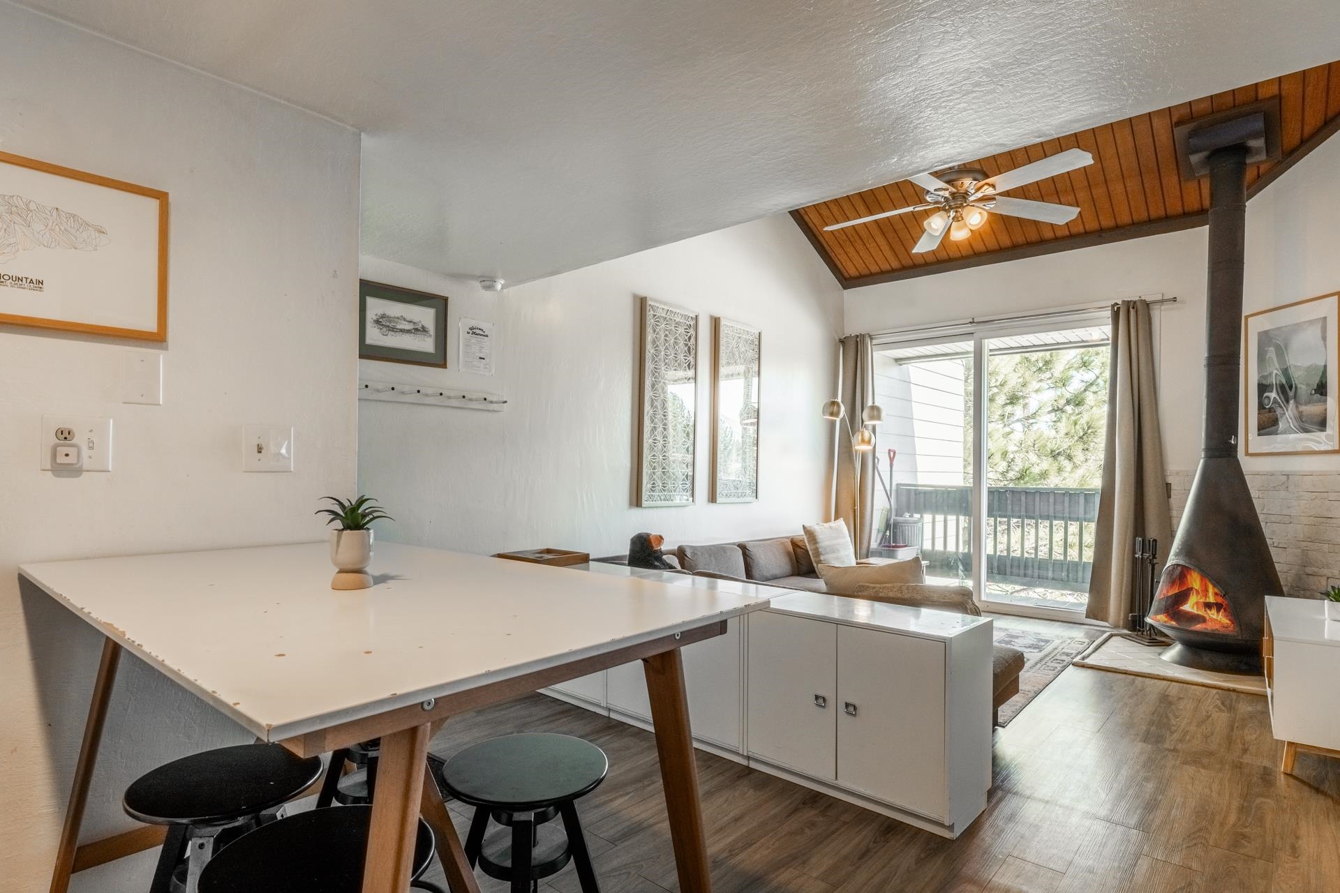 137 Laurel Mountain Road, Unit 227 Mammoth Lakes, CA 93546 - Photo 11 of 28 Kitchen with a wood stove, a peninsula, a breakfast bar, light countertops, and a vaulted wood ceiling