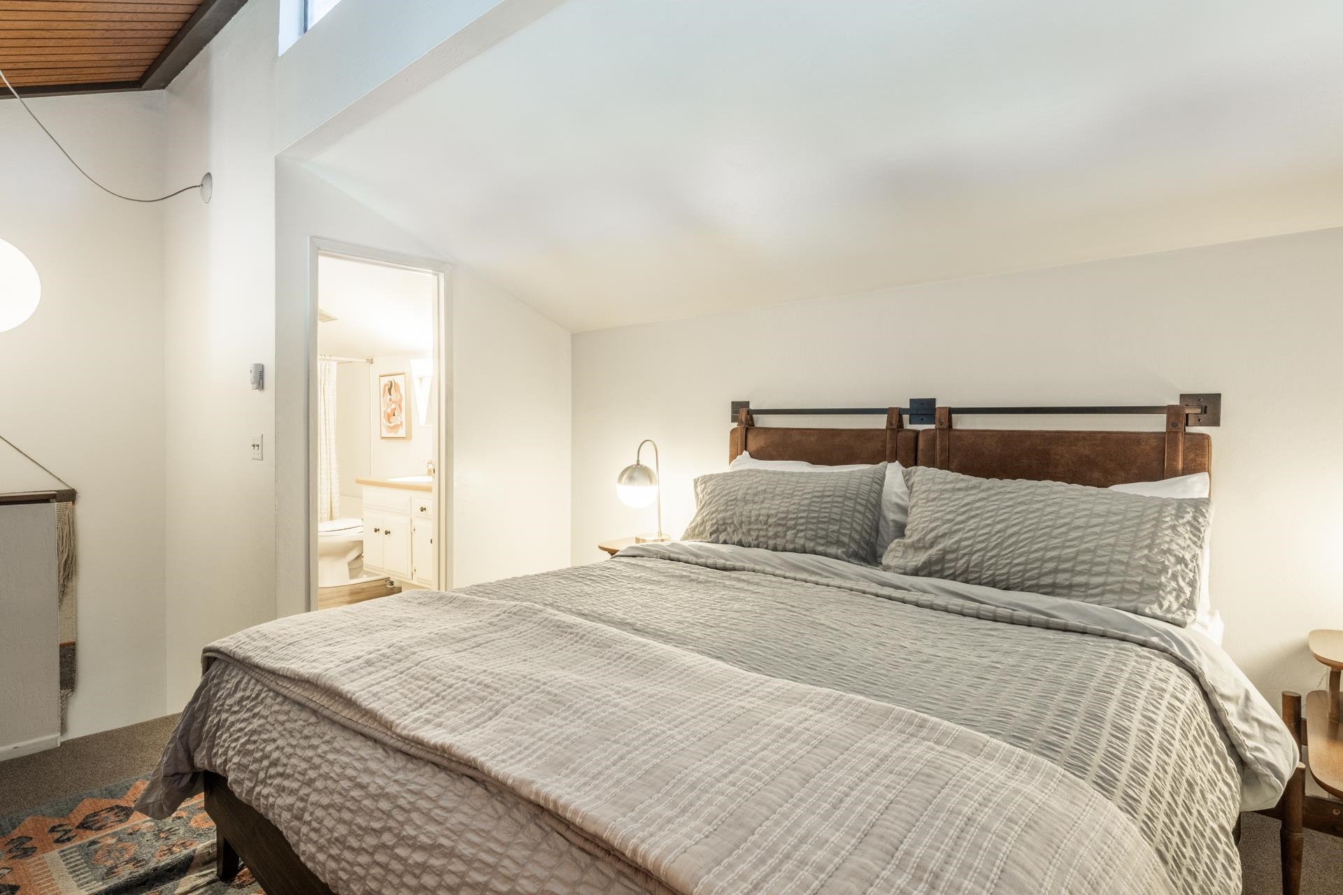 137 Laurel Mountain Road, Unit 227 Mammoth Lakes, CA 93546 - Photo 17 of 28 Bedroom featuring carpet flooring, ensuite bathroom, and vaulted ceiling