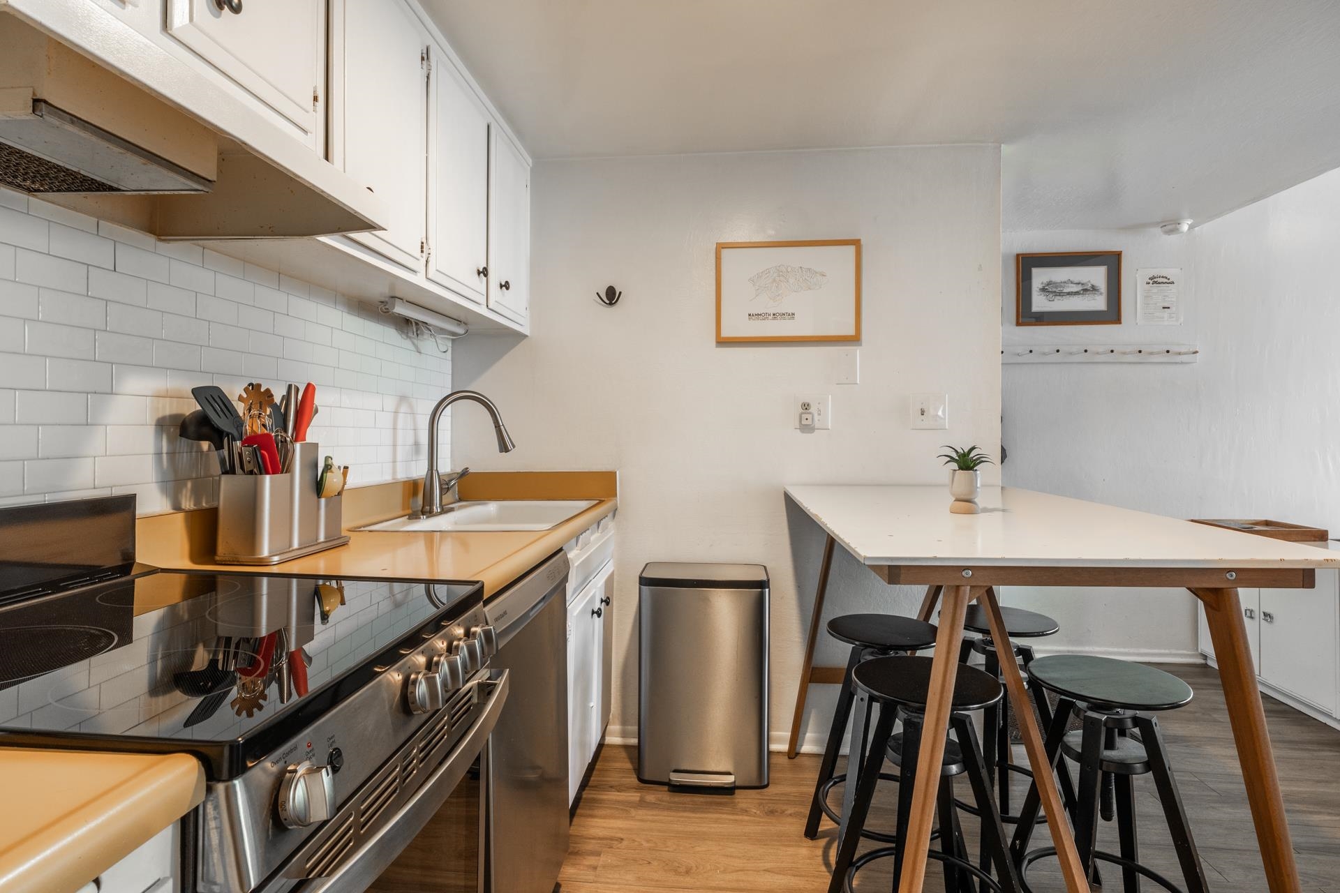 137 Laurel Mountain Road, Unit 227 Mammoth Lakes, CA 93546 - Photo 10 of 28 Kitchen featuring a peninsula, light countertops, a kitchen breakfast bar, and stainless steel appliances