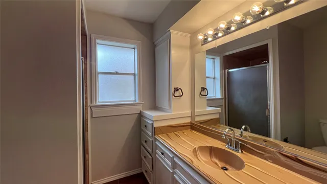 a bathroom with a sink and a large mirror