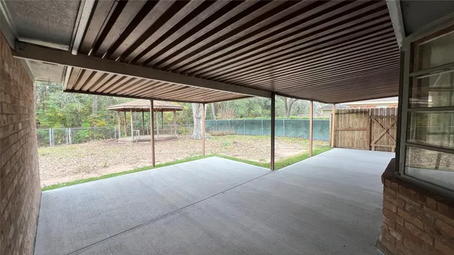 a backyard of a house with table and chairs