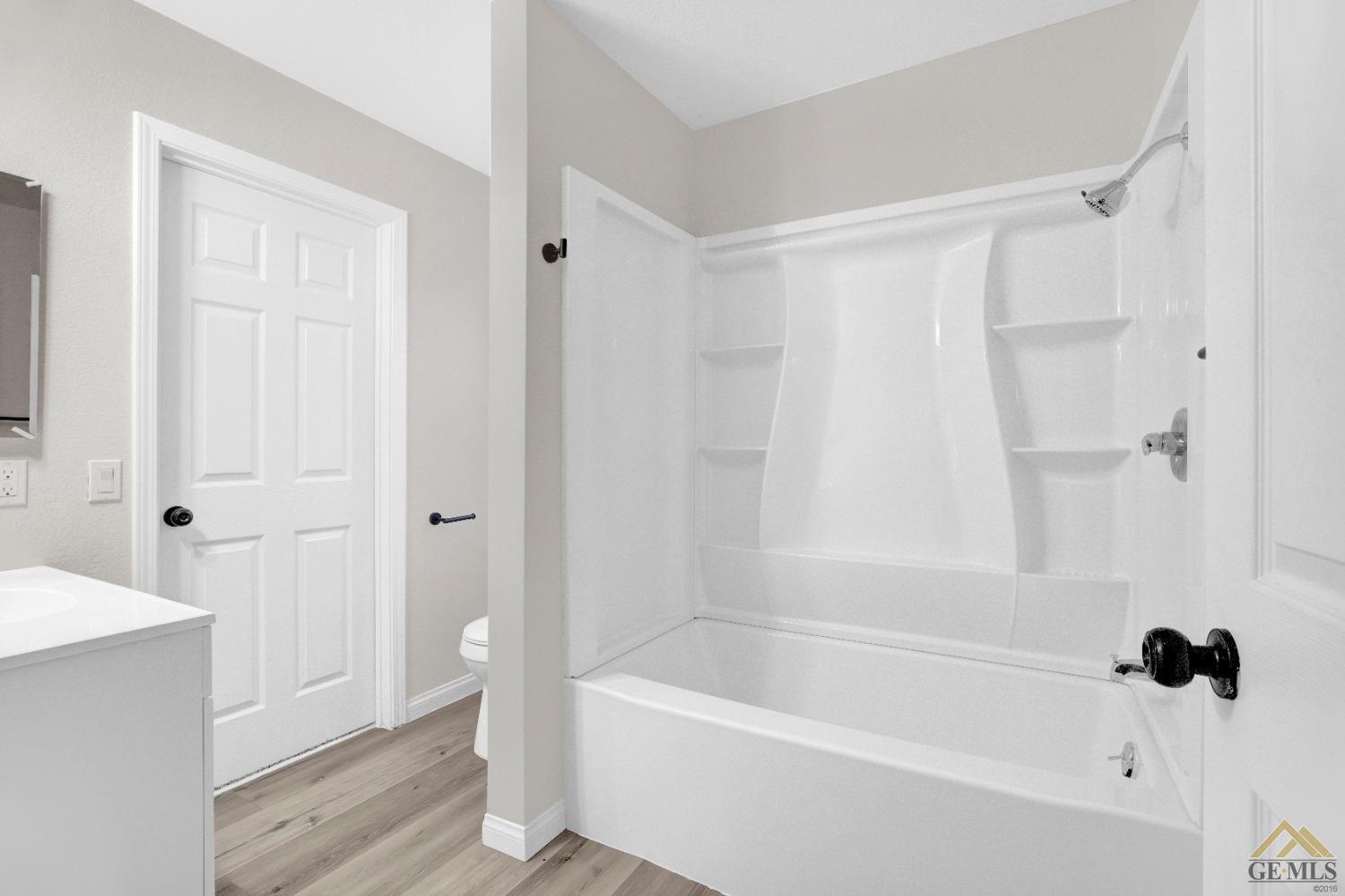 Undisclosed Address Bakersfield, CA 93304 - Photo 14 of 32 a bathroom with a bathtub