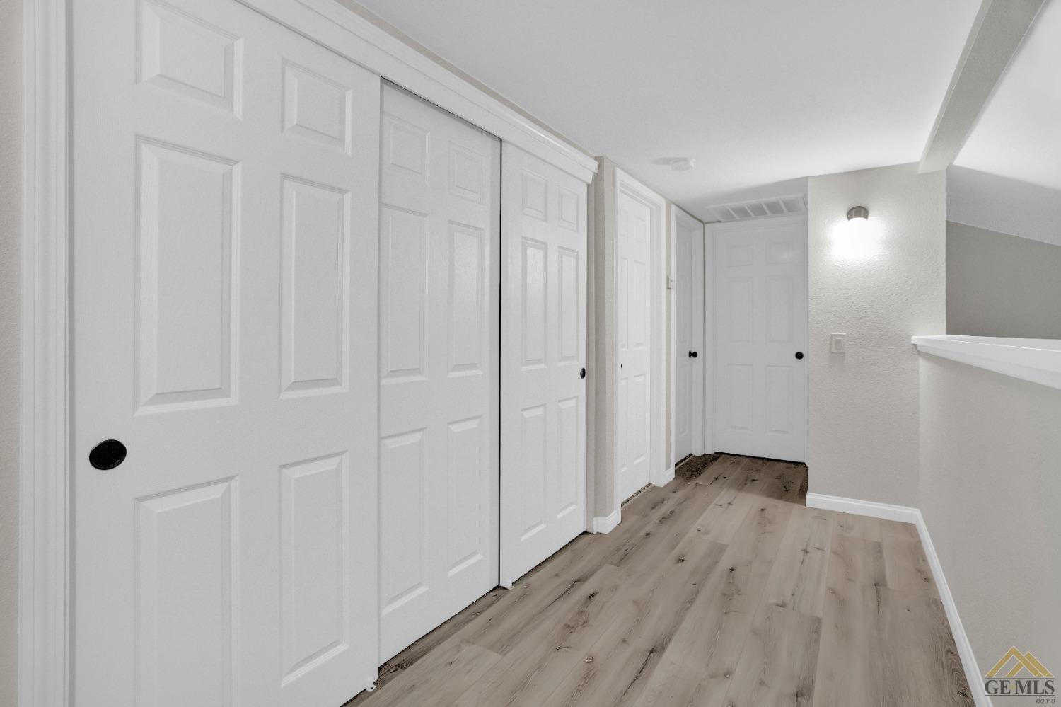 Undisclosed Address Bakersfield, CA 93304 - Photo 19 of 32 a view of a hallway with wooden floor