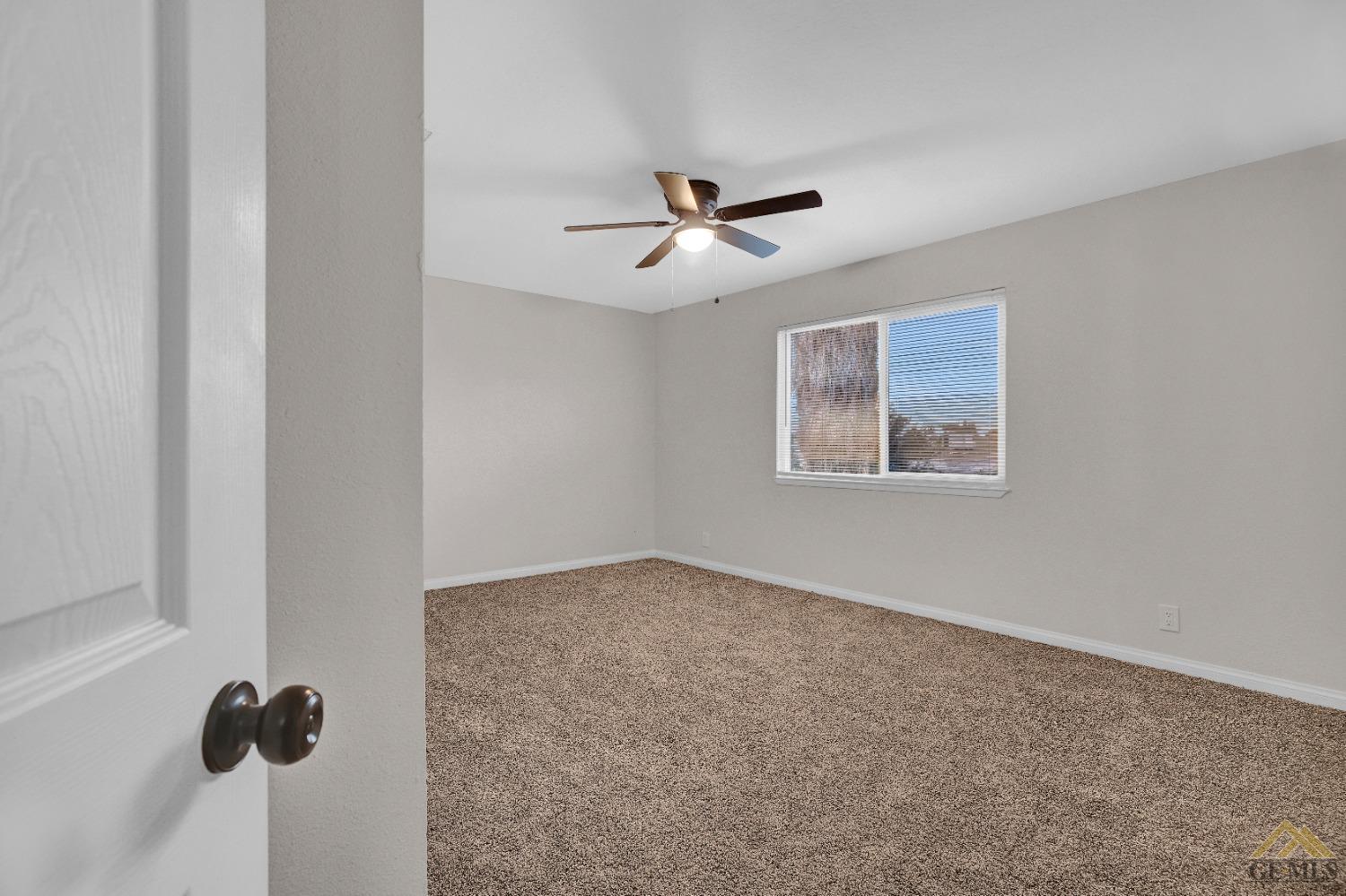 Undisclosed Address Bakersfield, CA 93304 - Photo 23 of 32 an empty room with windows and fan
