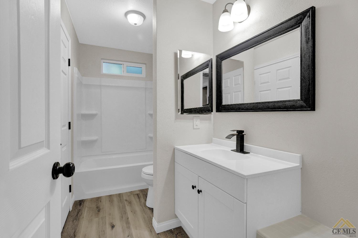 Undisclosed Address Bakersfield, CA 93304 - Photo 27 of 32 a bathroom with a sink a mirror and a bathtub