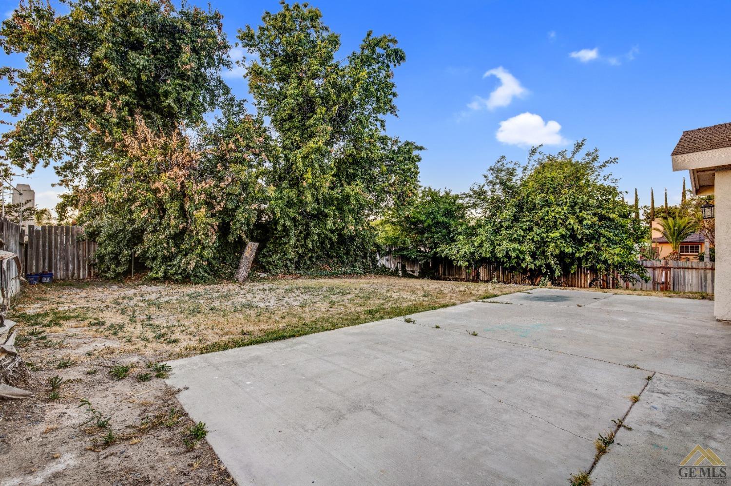Undisclosed Address Bakersfield, CA 93304 - Photo 31 of 32 a view of a yard with a tree