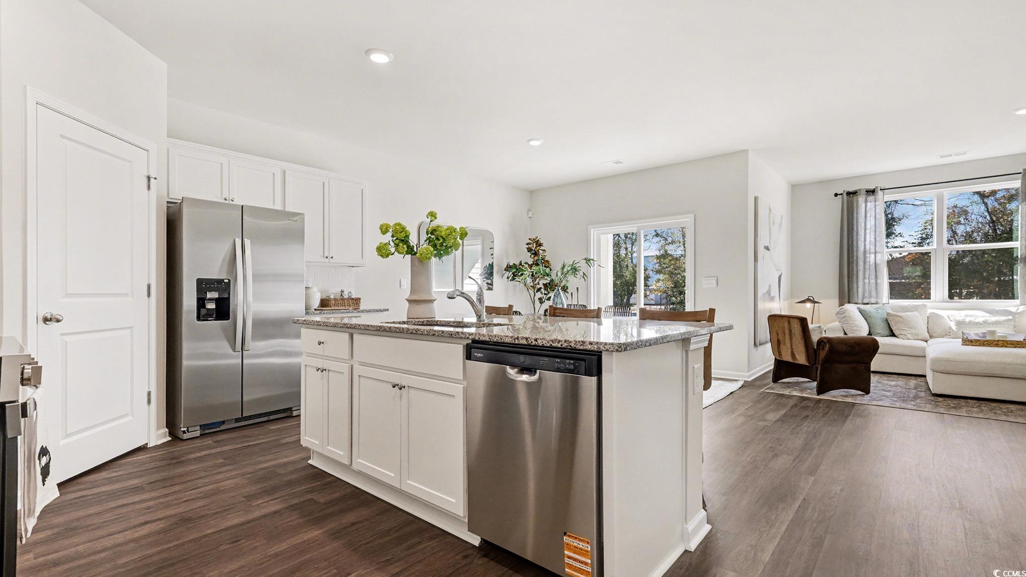 312 RookRoost Circle Conway, SC 29526 - Photo 29 of 29 Kitchen featuring white cabinetry, appliances with stainless steel finishes, open floor plan, dark wood finished floors, and a kitchen island with sink