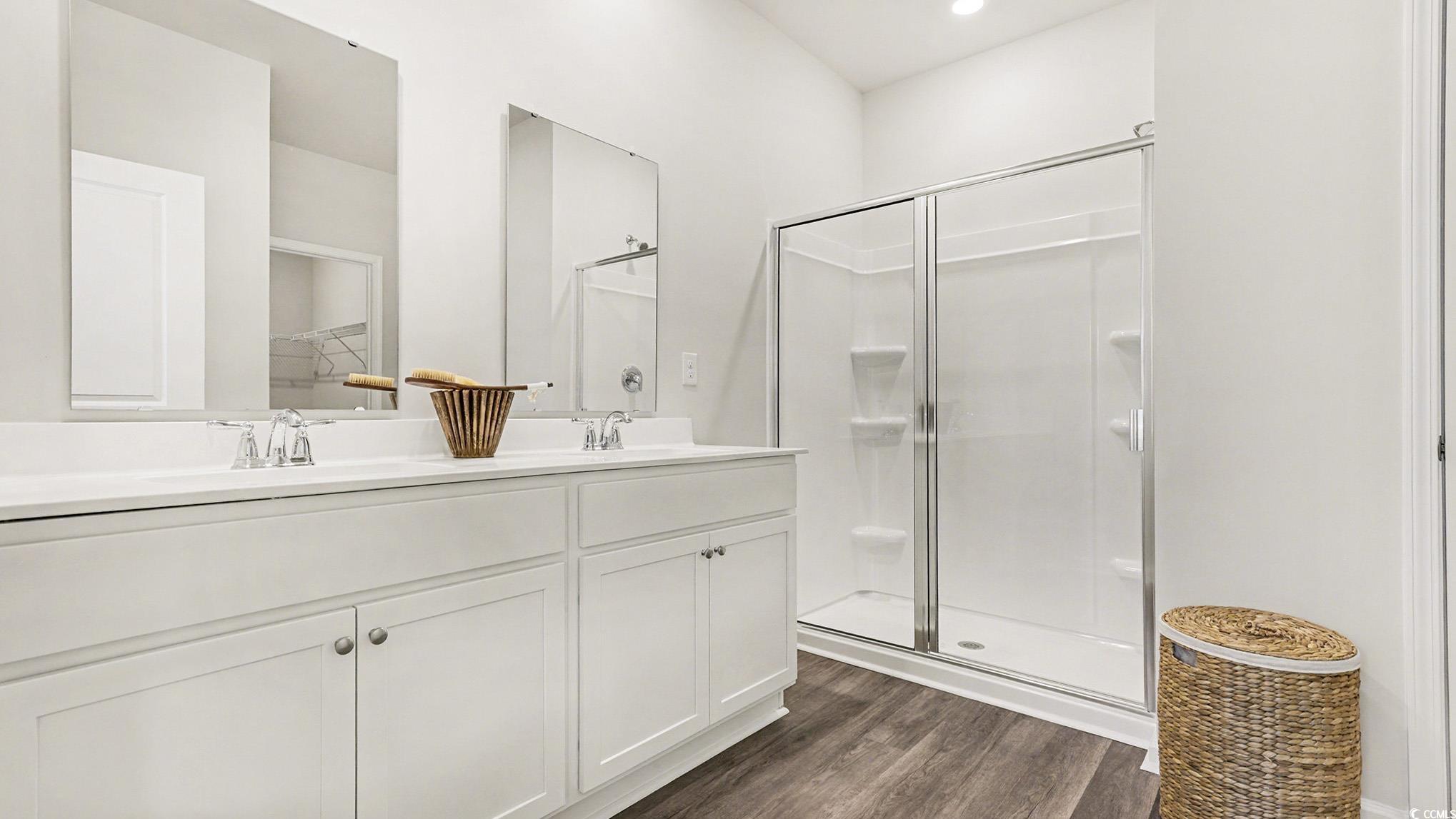 312 RookRoost Circle Conway, SC 29526 - Photo 19 of 29 Full bath featuring a stall shower, double vanity, and dark wood-style floors