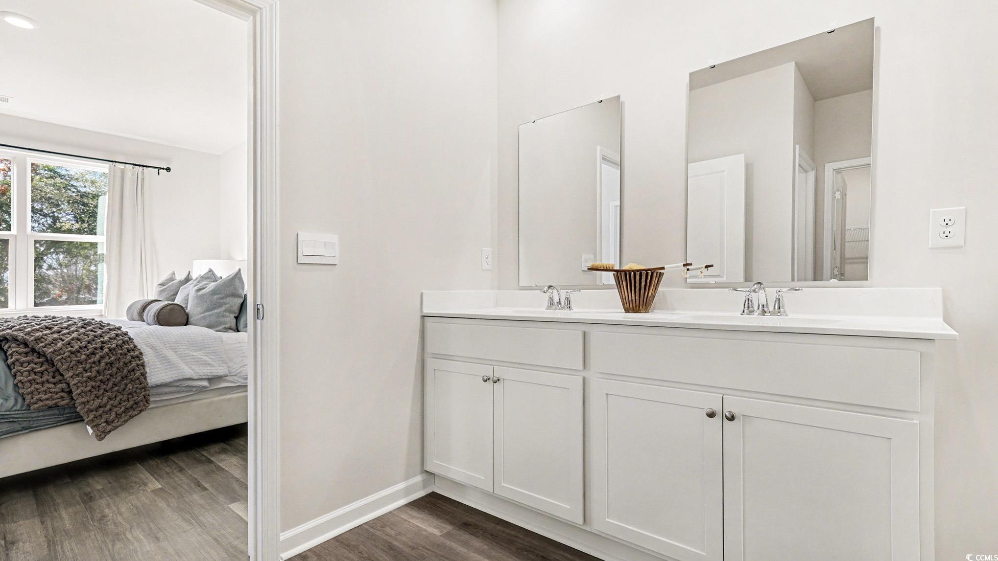 312 RookRoost Circle Conway, SC 29526 - Photo 20 of 29 Bathroom featuring double vanity, dark wood-type flooring, and connected bathroom