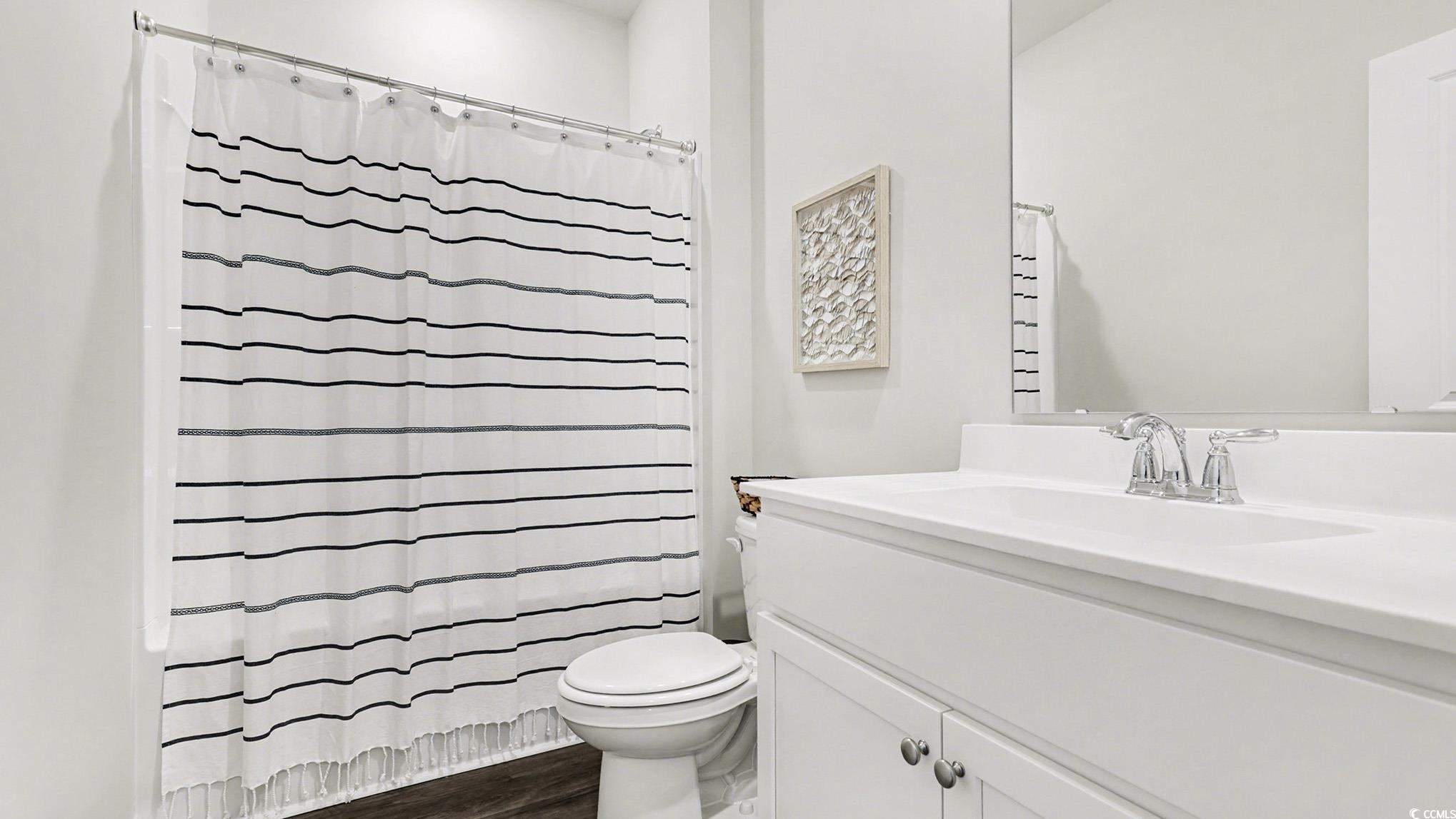 312 RookRoost Circle Conway, SC 29526 - Photo 25 of 29 Full bathroom with vanity, dark wood-type flooring, and shower / tub combo
