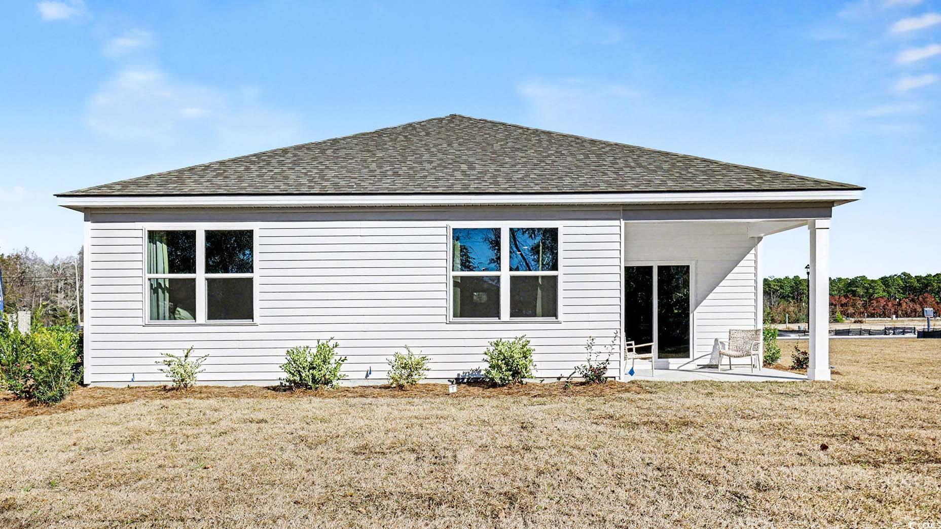 312 RookRoost Circle Conway, SC 29526 - Photo 28 of 29 Back of house featuring roof with shingles, a yard, and a patio