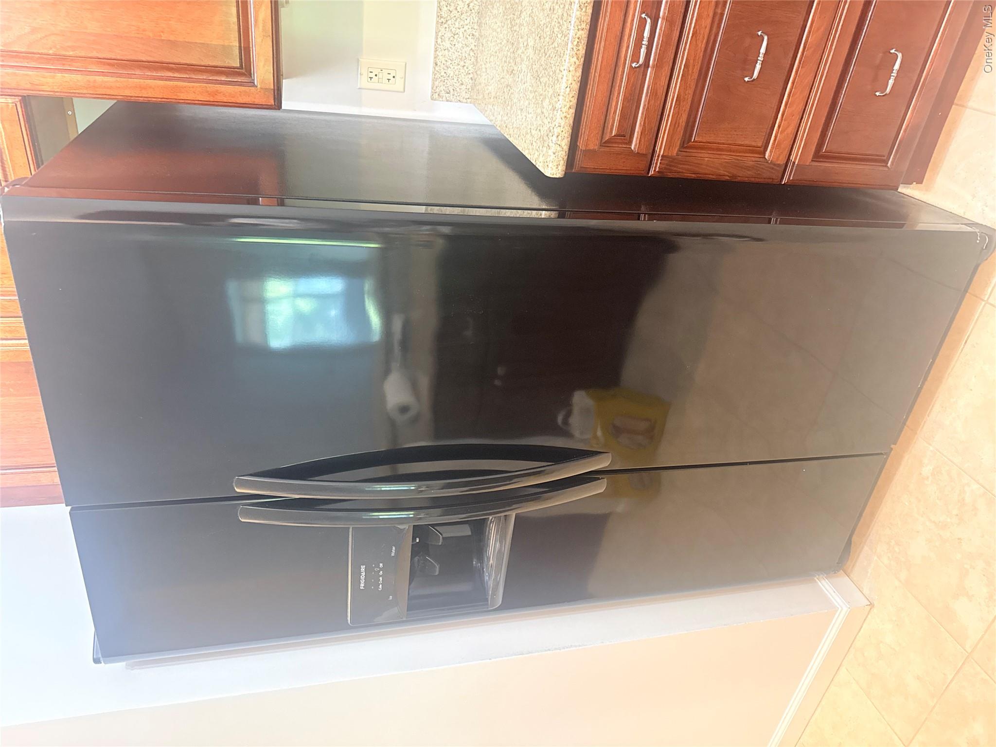 935 Tower Ridge Circle Middletown, NY 10941 - Photo 18 of 24 Black side-by-side refrigerator featuring an external ice and water dispenser