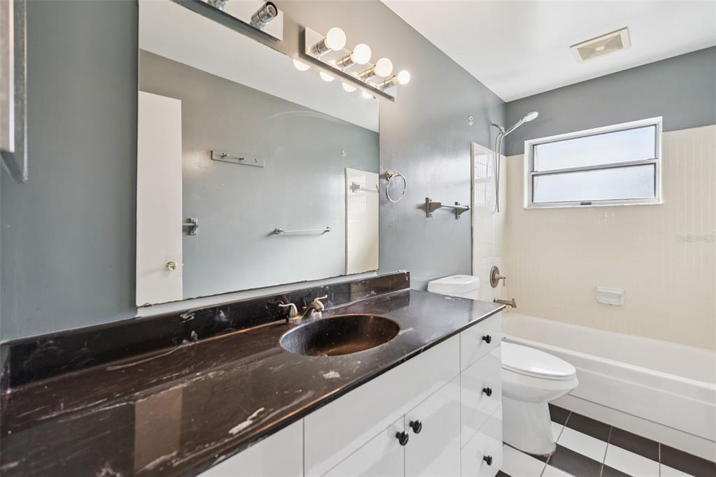 116 Hampden Road Winter Haven, FL 33884 - Photo 12 of 19 a bathroom with a sink double vanity granite tub and a mirror