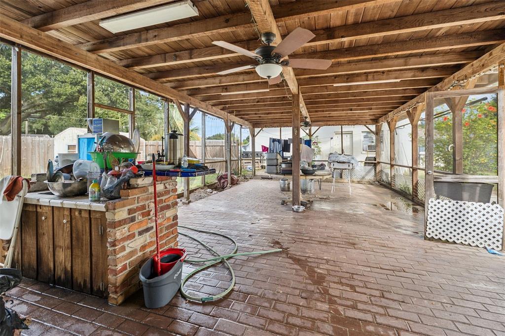 116 Hampden Road Winter Haven, FL 33884 - Photo 13 of 19 a view of a patio with table and chairs potted plants with wooden floor