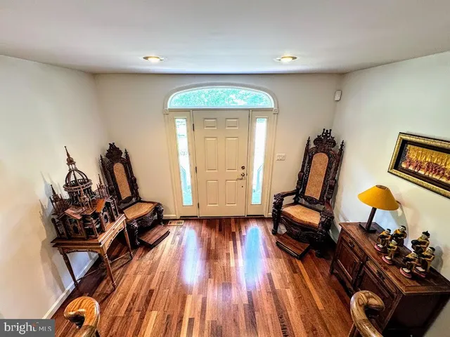 a kitchen with stainless steel appliances granite countertop a sink a stove a dining table and chairs