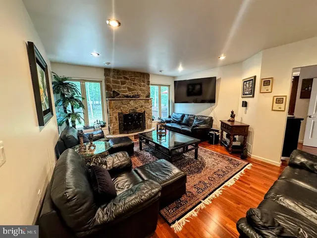a living room with furniture a piano and a window