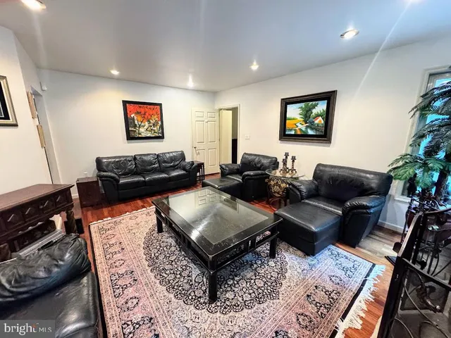 a bedroom with furniture and a large window