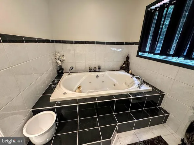 a living room with furniture and a mirror