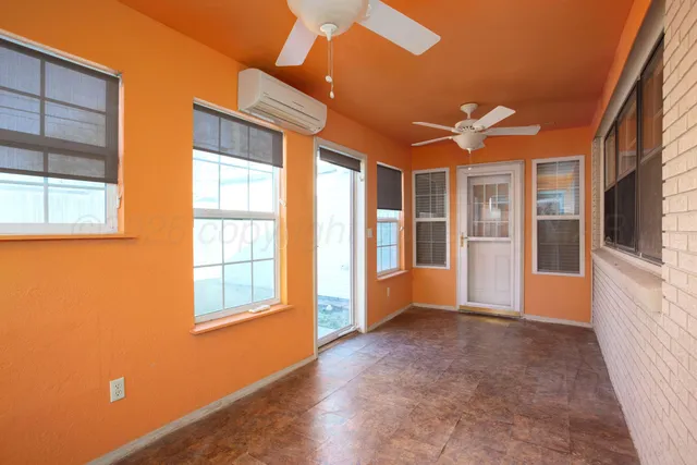 a kitchen with red cabinets and window