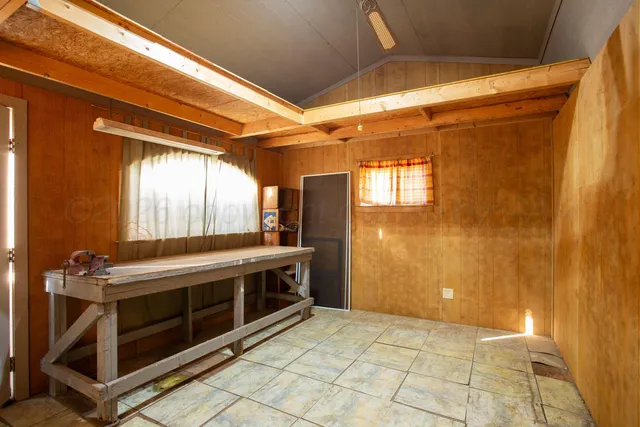 a backyard of a house with a basket ball court