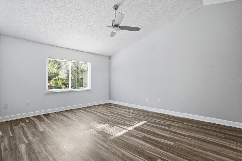 5277 Deltona Boulevard Spring Hill, FL 34606 - Photo 13 of 74 wooden floor in an empty room with a window