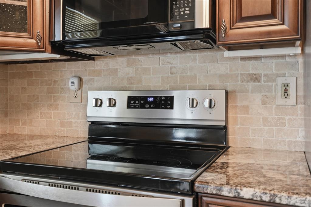 5277 Deltona Boulevard Spring Hill, FL 34606 - Photo 19 of 74 a stove top oven sitting inside of a kitchen