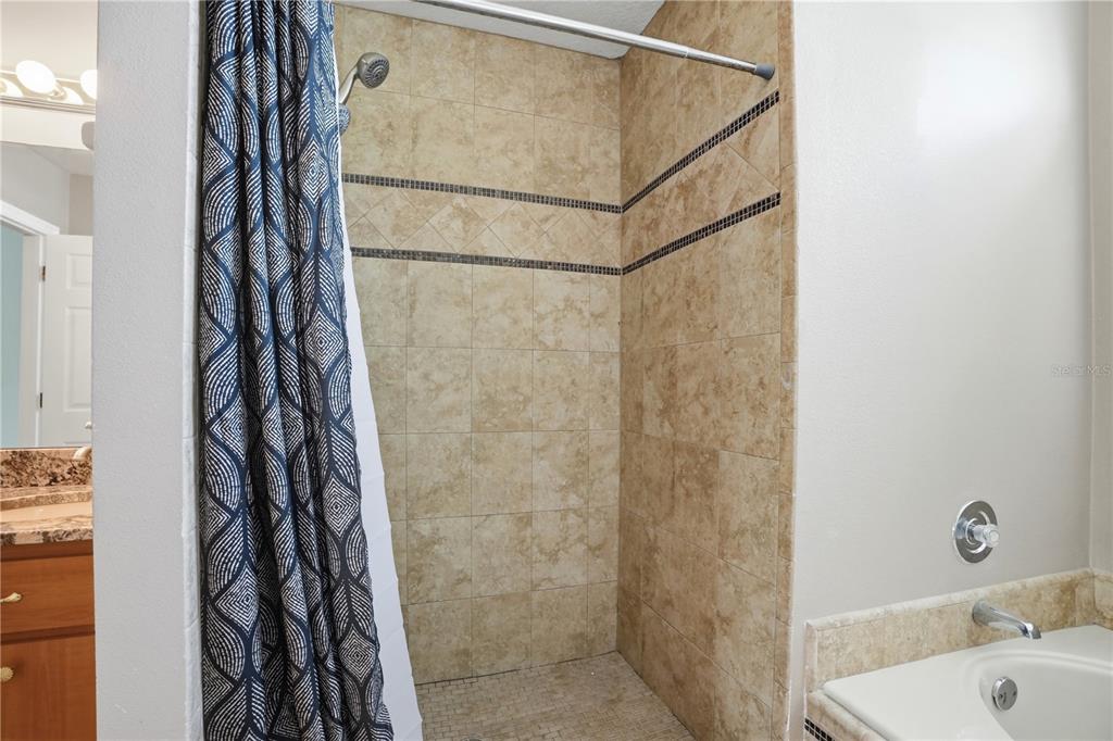 5277 Deltona Boulevard Spring Hill, FL 34606 - Photo 30 of 74 a bathroom with a shower curtain and a sink