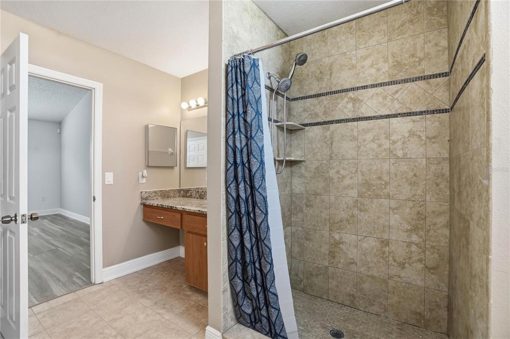5277 Deltona Boulevard Spring Hill, FL 34606 - Photo 32 of 74 a bathroom with a shower and a sink