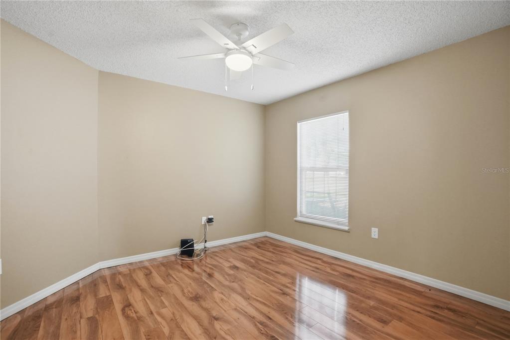 5277 Deltona Boulevard Spring Hill, FL 34606 - Photo 38 of 74 an empty room with a window and a ceiling fan