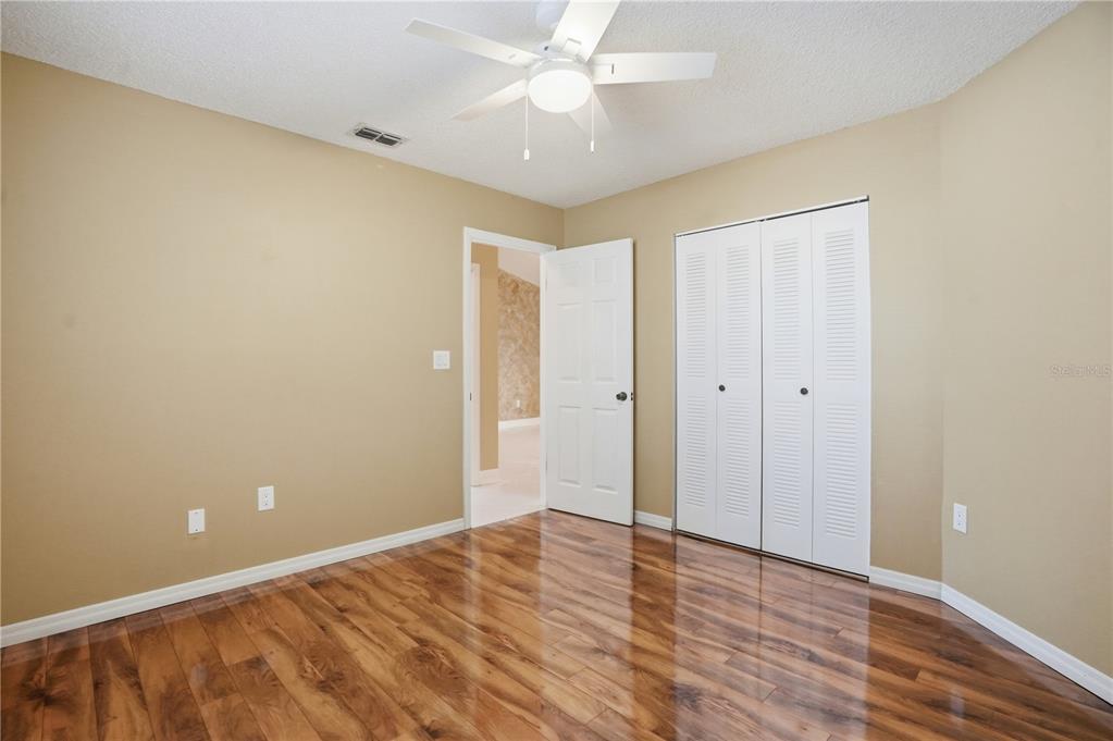 5277 Deltona Boulevard Spring Hill, FL 34606 - Photo 40 of 74 a view of an empty room with wooden floor