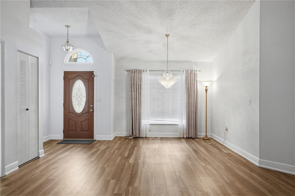 5277 Deltona Boulevard Spring Hill, FL 34606 - Photo 4 of 74 a view of empty room with wooden floor and window